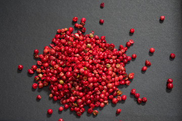 close up on red peppercorn isolated on black background 