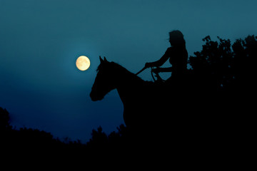 Full moon with silhouette of horse rider night sky, horror concept in Fantasy World. Horseback  riding, woman under nature moon. Atmosphere moonlight landscape background for halloweens nightmare