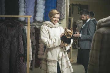 Couple in love tries expensive mink overcoat on