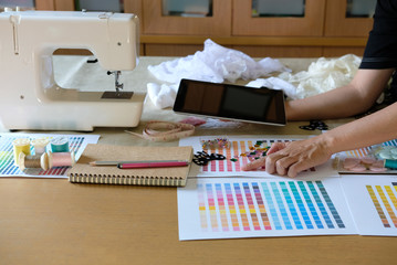 equipment on fashion designer working in studio with equipment on desk. design thing in atelier