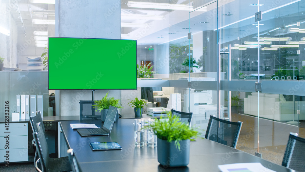 Poster modern empty meeting room with big conference table with various documents and laptops on it, on the
