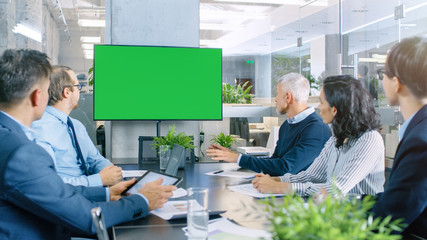 Diverse Group of Successful Business People in the Conference Room with  Green Screen Chroma Key TV...