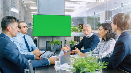 Diverse Group of Successful Business People in the Conference Room with  Green Screen Chroma Key TV...