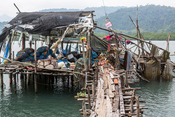 Fishing tackle on Pier made of wooden planks in the fishing village on Ko Chang island, Thailand.