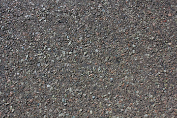 Dark urban asphalt road surface background, rough bitumen texture.