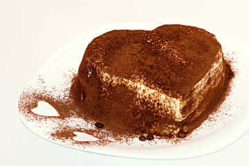 Tiramisu cake, cake tiramisu with berries. A cake of tiramisu sprinkled with berries in the form of a heart.