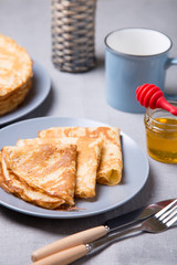 Traditional Russian pancakes with honey. Shrovetide. Maslenitsa week. Selective focus, close-up.