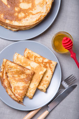 Traditional Russian pancakes with honey. Shrovetide. Maslenitsa week. Selective focus, close-up.