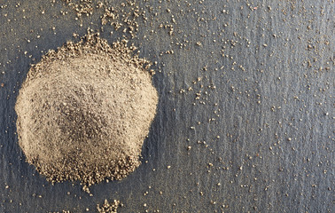 Pile of roughly milled black pepper spice.Top view.