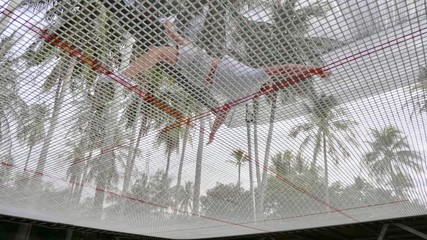 Professional gymnast jumping on the trampoline and doing tricks in air