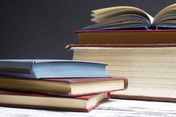 Open book, hardback books on wooden table. Back to school. Copy space