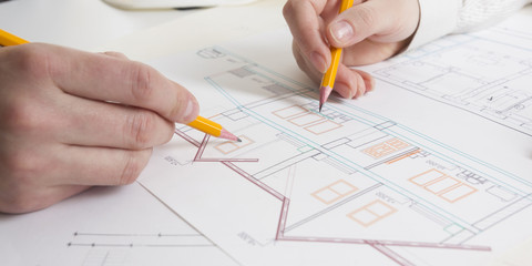 Architects working on blueprint, real estate project. Architect workplace - architectural project, blueprints, ruler, calculator, laptop and divider compass. Construction concept. Engineering tools.
