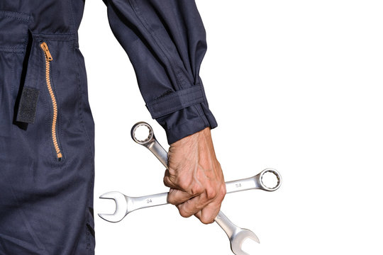 Car repairman wearing a dark blue uniform standing and holding a wrench that is an essential tool for a mechanic isolated on white background, Automotive industry and garage concepts.