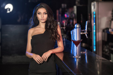Elegant young lady at the bar.