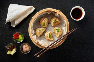 Fototapeta na wymiar Dim sum dumplings in steamer and ingredients top view
