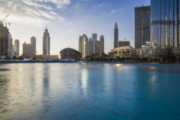 Fototapeta na wymiar Downtown Dubai skyline, view from the Dubai fountain to the Opera Theatre. Modern city cityscape with skyscrapers. Dubai, UAE.