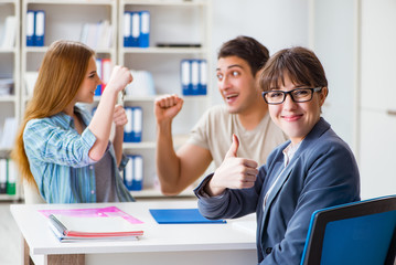 Young family agreeing mortgage contract in the bank for new house