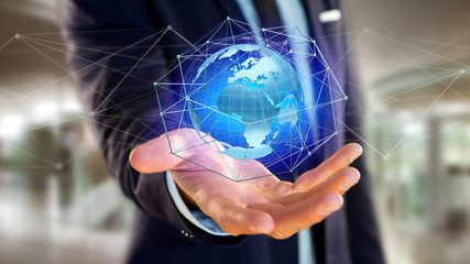 Businessman holding a Connected network over a earth globe concept on a futuristic interface - 3d rendering