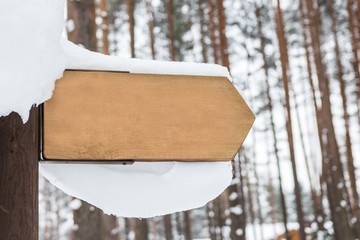 Wooden sign with snow on it