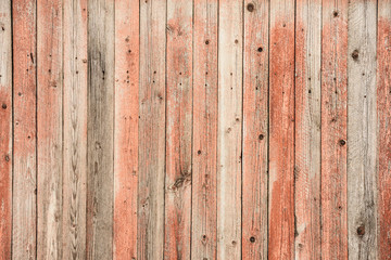Old red wooden wall with knots. Texture and background.