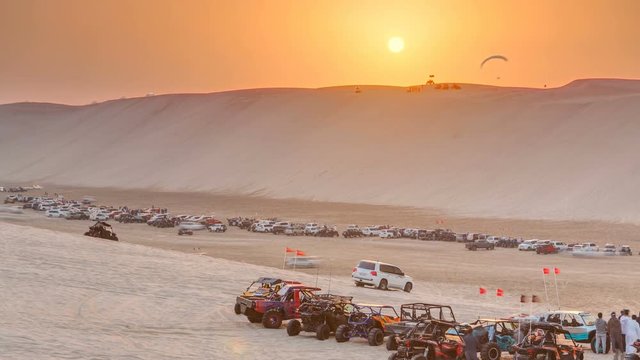 Buggies in sand desert at the sunset timelapse