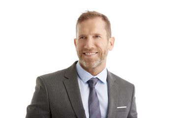 Senior businessman. Studio portrait of a middle aged man wearing suit and standing against at isolated white background.