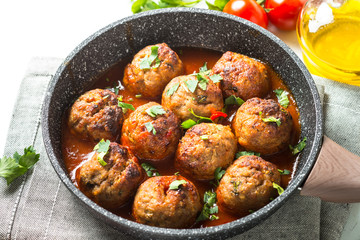 Meat balls in tomato sauce in a frying pan. 