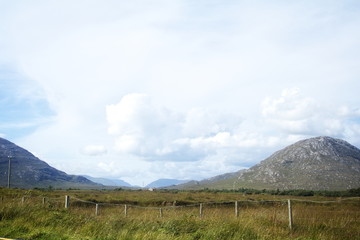 A landscape with mountains and a shed.