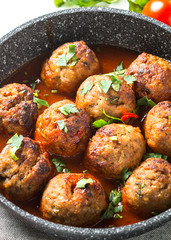 Meat balls in tomato sauce in a frying pan. 