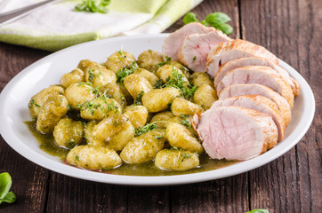 Pork tenderloin with herbs and spices, pesto gnocchi