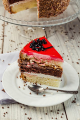 sponge cake with fruit jelly on wooden background