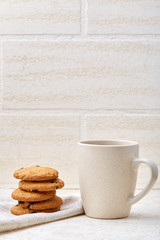 Cup of coffee and biscuit isolated on the white background, close-up, shallow depth of field.