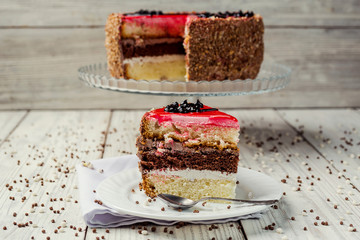 sponge cake with fruit jelly on wooden background