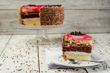 sponge cake with fruit jelly on wooden background