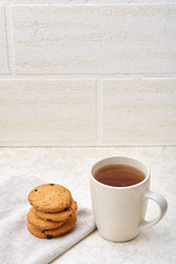 Cup of coffee and biscuit isolated on the white background, close-up, shallow depth of field.
