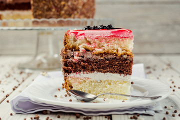 sponge cake with fruit jelly on wooden background