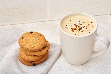 Cup of coffee and biscuit isolated on the white background, close-up, shallow depth of field.