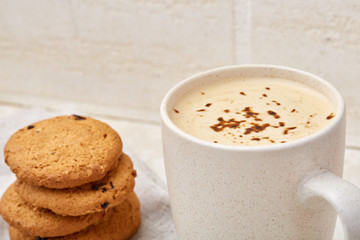 Cup of coffee and biscuit isolated on the white background, close-up, shallow depth of field.