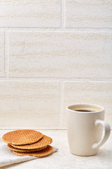 Cup of coffee and biscuit isolated on the white background, close-up, shallow depth of field