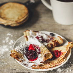 Pancakes (crepes) on a wooden surface