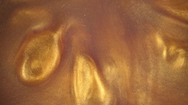 4K footage. Ink in water. Gold ink reacting in water creating abstract background.
