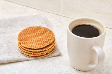 Cup of coffee and biscuit isolated on the white background, close-up, shallow depth of field