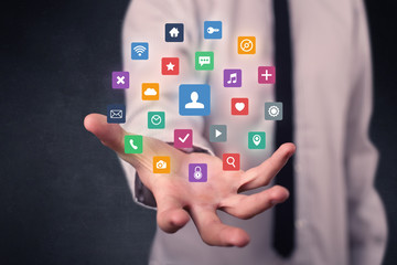 Businessman holding colorful applications