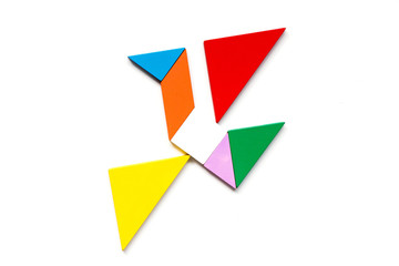 Color wood tangram puzzle in flying bird shape on white background