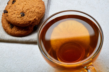 Top view close up picture of glass teacup with biscuits isolated on white background, frontfocus, shallow depth of field