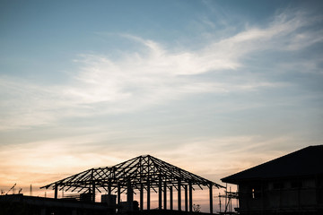silhouette house building at construction site sunset background