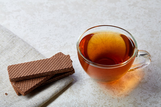 Top view close up picture of glass teacup with waffles isolated on white background, shallow depth of field