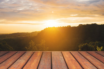 Fototapeta na wymiar Empty wooden floor and sunset landscape view.