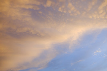 Naklejka na ściany i meble Orange clouds with blue sky sunset moment