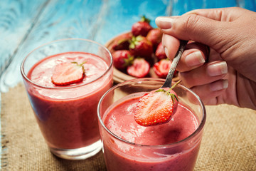 healthy strawberry yogurt with fresh berries on old wooden background